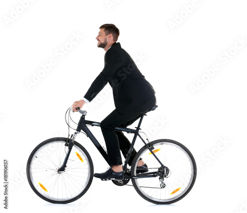 Fototapeta Naklejka Na Ścianę i Meble -  Handsome businessman riding bicycle on white background
