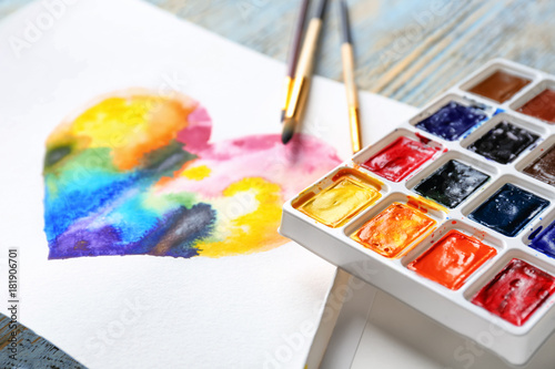 Painting of rainbow heart on table, closeup