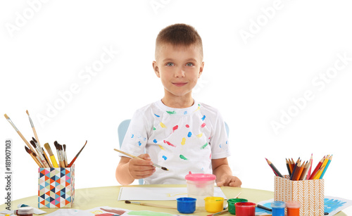 Cute little boy painting at...