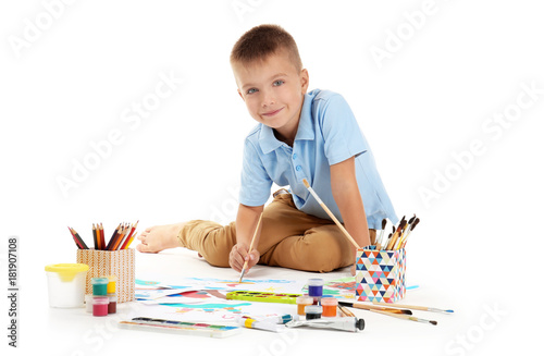Cute little boy painting ag...