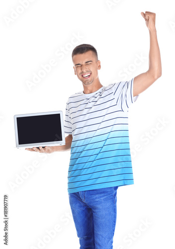 Happy young man with laptop...