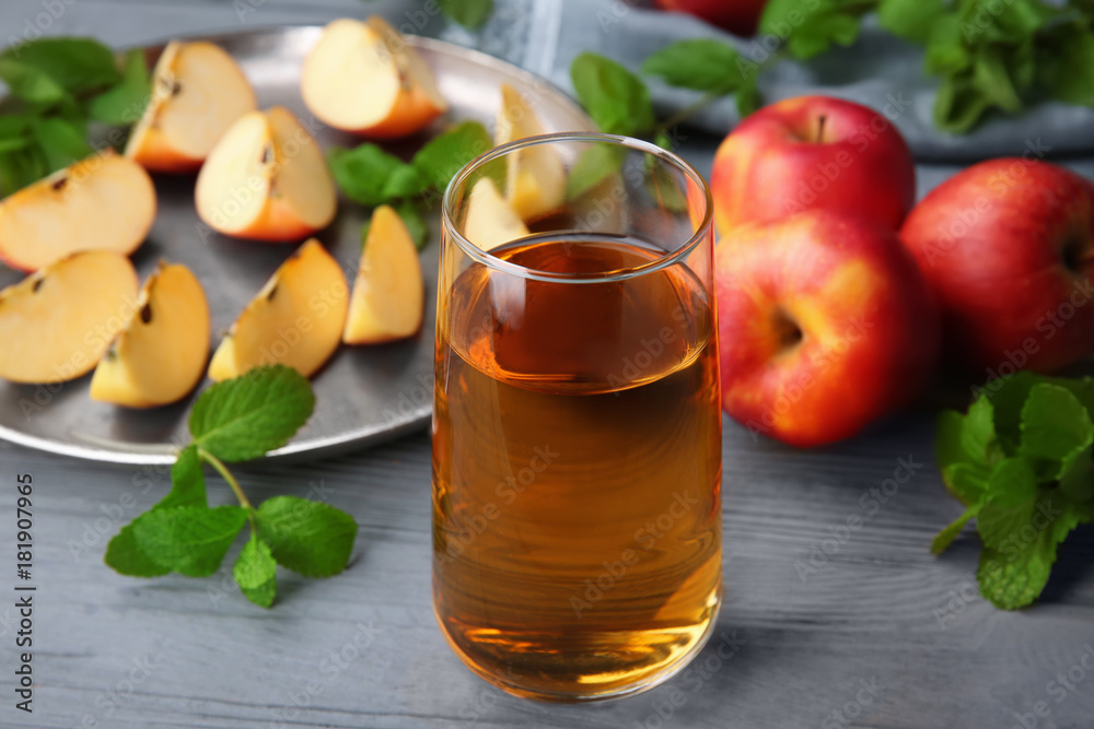 Glass with fresh apple juice on wooden table Glass with fresh apple juice on wooden table