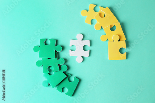Composition with different puzzles on color background. Concept of autism