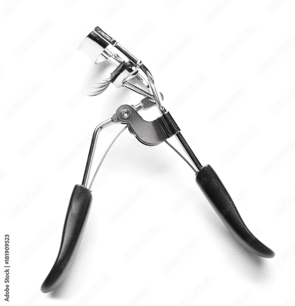 Curler and false eyelashes on white background