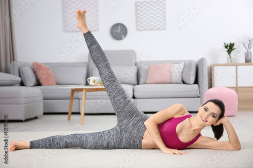 Young sporty woman doing ex...
