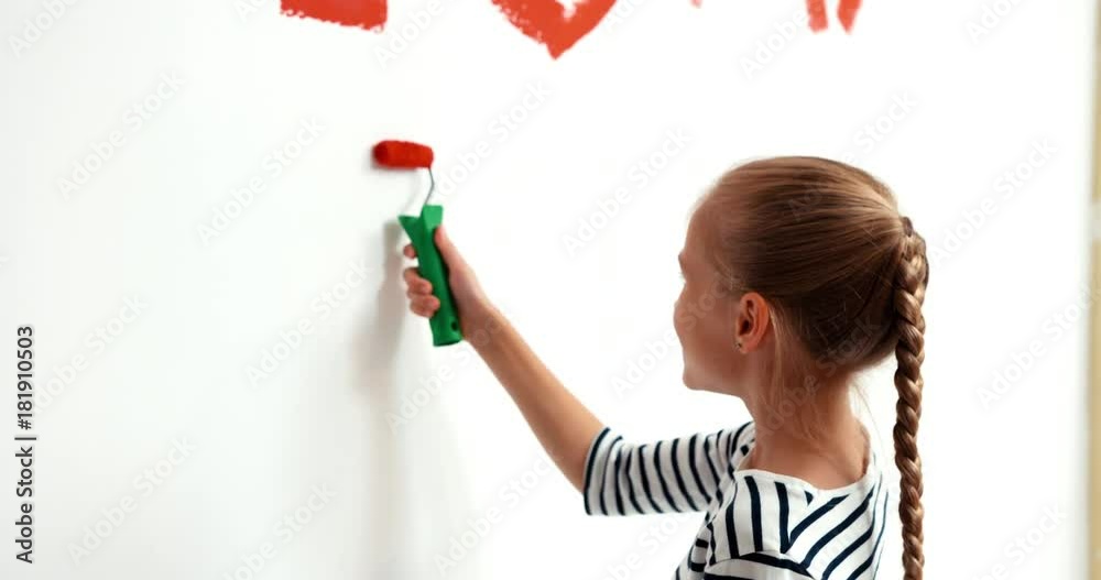 Child girl 9 years old writing on the wall Child girl 9 years old writing on the wall
