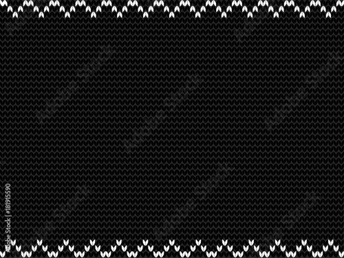 Charcoal black fabric knitted background framed with knit white zig zag pattern.