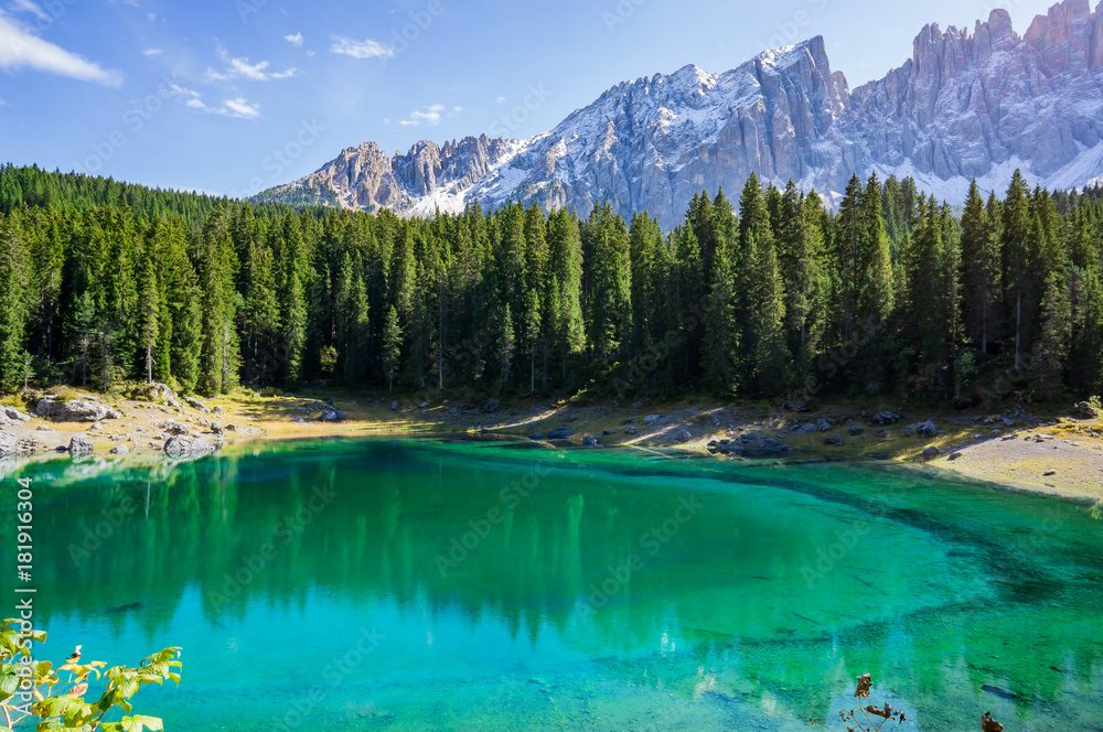 Beautiful view alpine lake with mountains in the Dolomites in South Tyrol, Italy.  Lago di Carezza, Karersee.