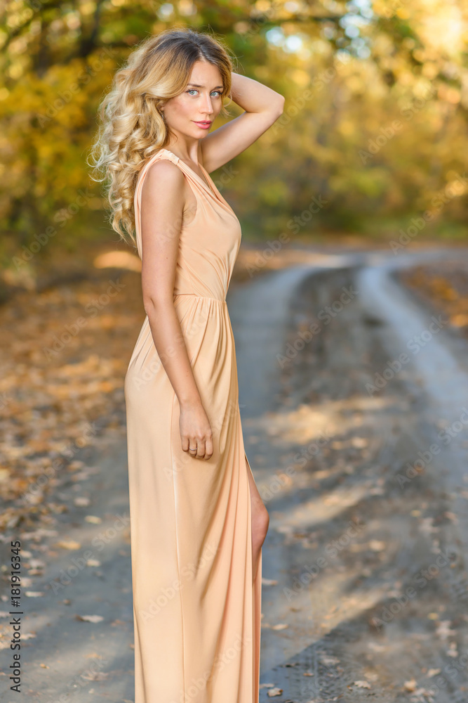 Beautiful blonde woman close up portrait. Blue eyes, curled hair. Autumn backgrounds Beautiful blonde woman close up portrait. Blue eyes, curled hair. Autumn backgrounds