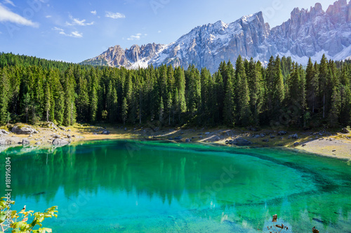 Beautiful view alpine lake with mountains in the Dolomites in South Tyrol, Italy. Lago di Carezza, Karersee.