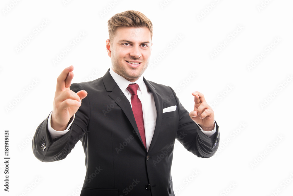 Handsome business man smiling standing with fingers crossed Handsome business man smiling standing with fingers crossed