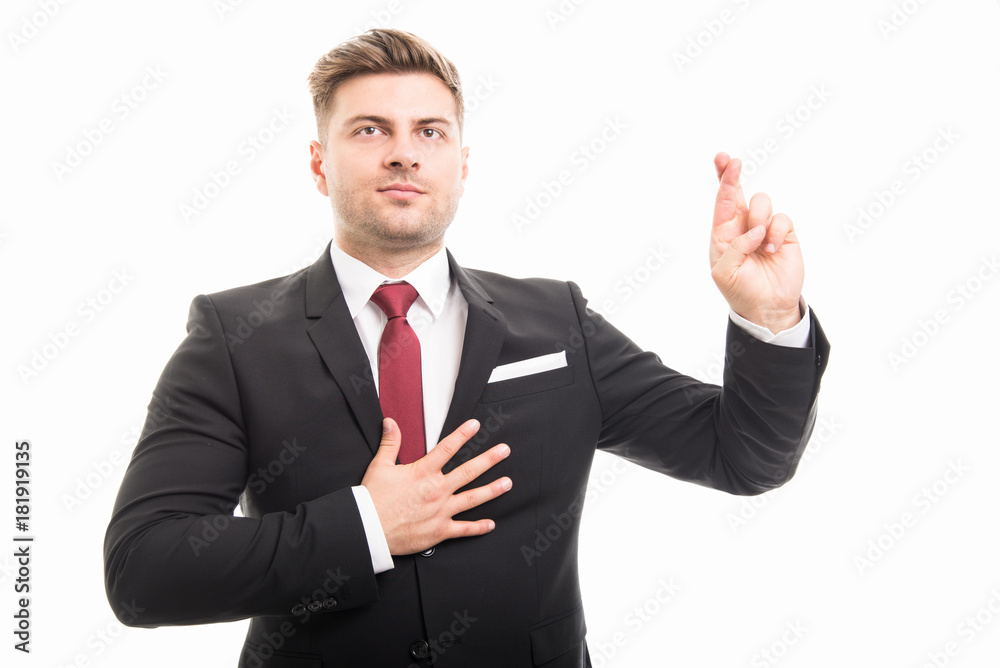 Handsome business man taking fingers crossed oath Handsome business man taking fingers crossed oath