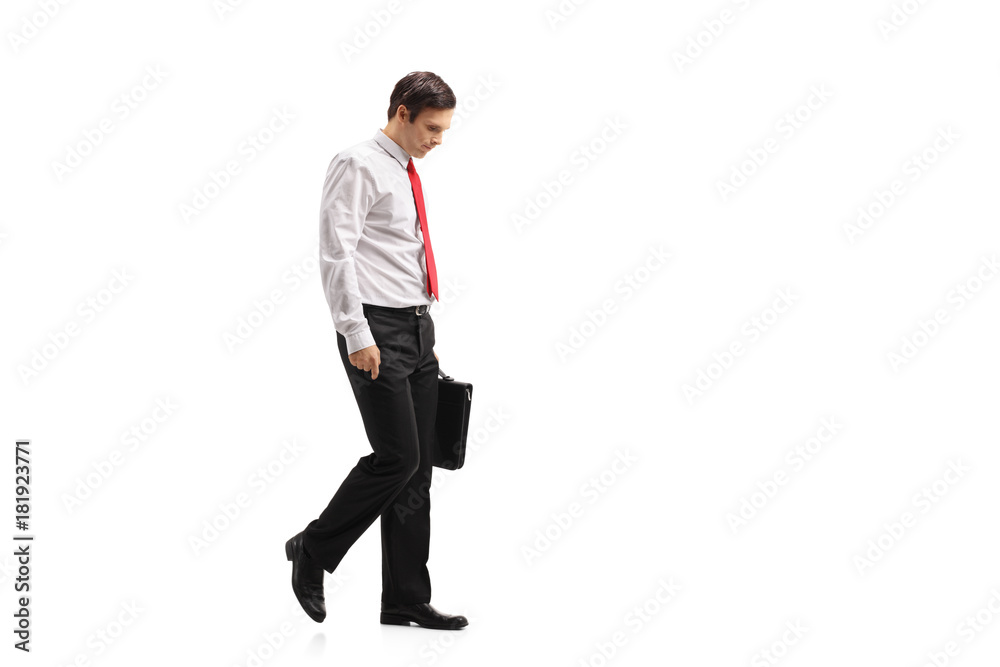 Depressed formally dressed guy with a suitcase walking Depressed formally dressed guy with a suitcase walking