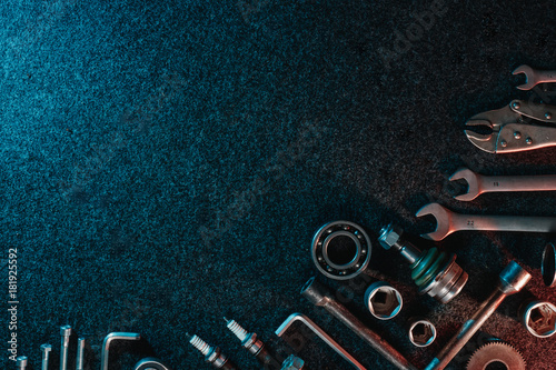Bearings, wrenches, bolts on a dark background. view from above. Flat design. Automotive subjects. Copy space.