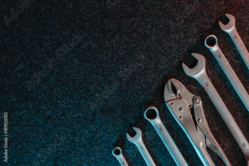 Spanners on a dark background. Top view, flat design. Automotive concept. Copy space.