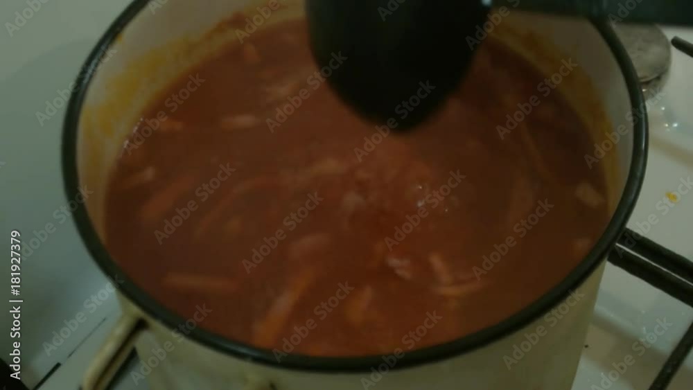 Male hands stir a ladle of the soup Solyanka. Russian cuisine. Male hands stir a ladle of the soup Solyanka. Russian cuisine.