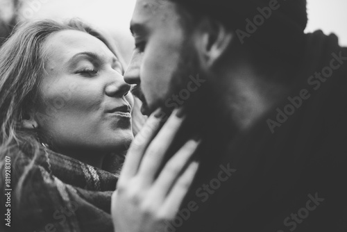 Outdoor happy couple in love posing in cold weather. Young boy and girl having fun outdoor