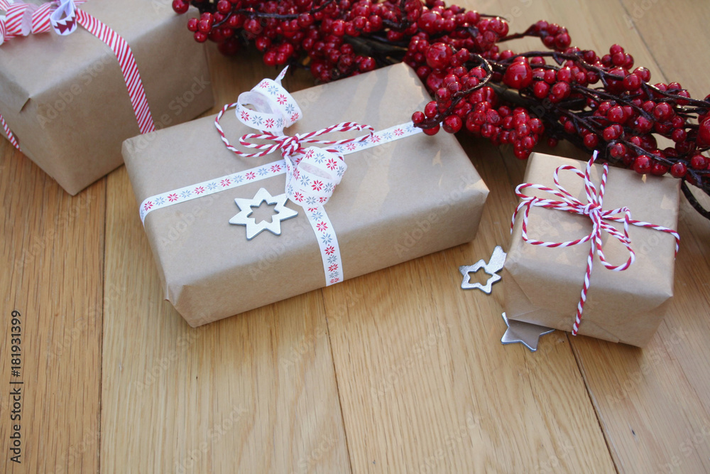 Pacchi regalo natalizi con fiocchi e decorazioni su tavolo di