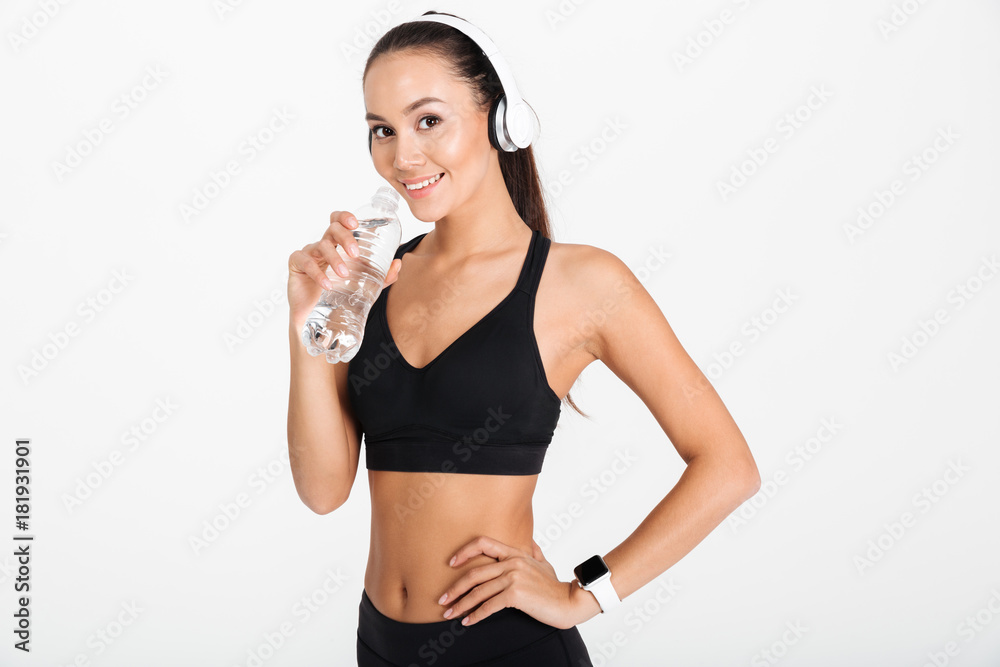 Portrait of a pretty asian fitness woman in headphones Portrait of a pretty asian fitness woman in headphones