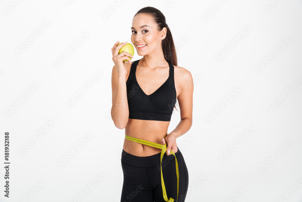 Portrait of a healthy asian fitness woman holding apple Portrait of a healthy asian fitness woman holding apple