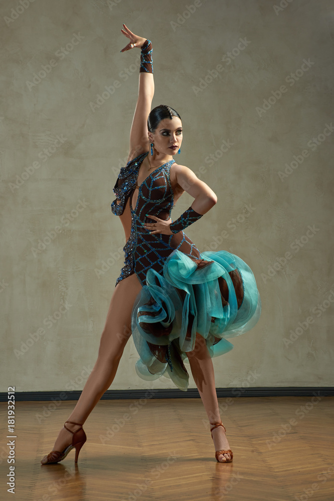 Attractive woman dancing ballroom dance in studio in gorgeous sexy latin  costume Stock Photo | Adobe Stock