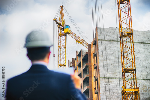 Architect engineer check documents and workflow on new building.