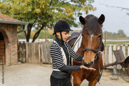 A horse eats from a girl's hand- Young girl feeds her horse out of her hand