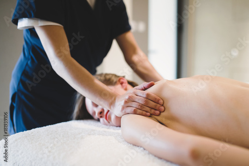 Masseur treating masseuse at wellness saloon
