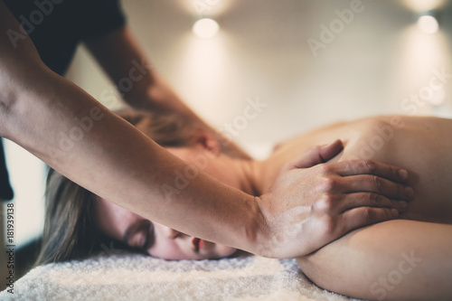 Masseur treating patient with therapeutic massage