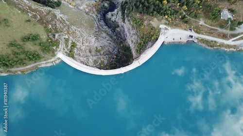 Drone aerial footage of reservoir lake and arch dam for renewable energy power plant in Switzerland Alps
