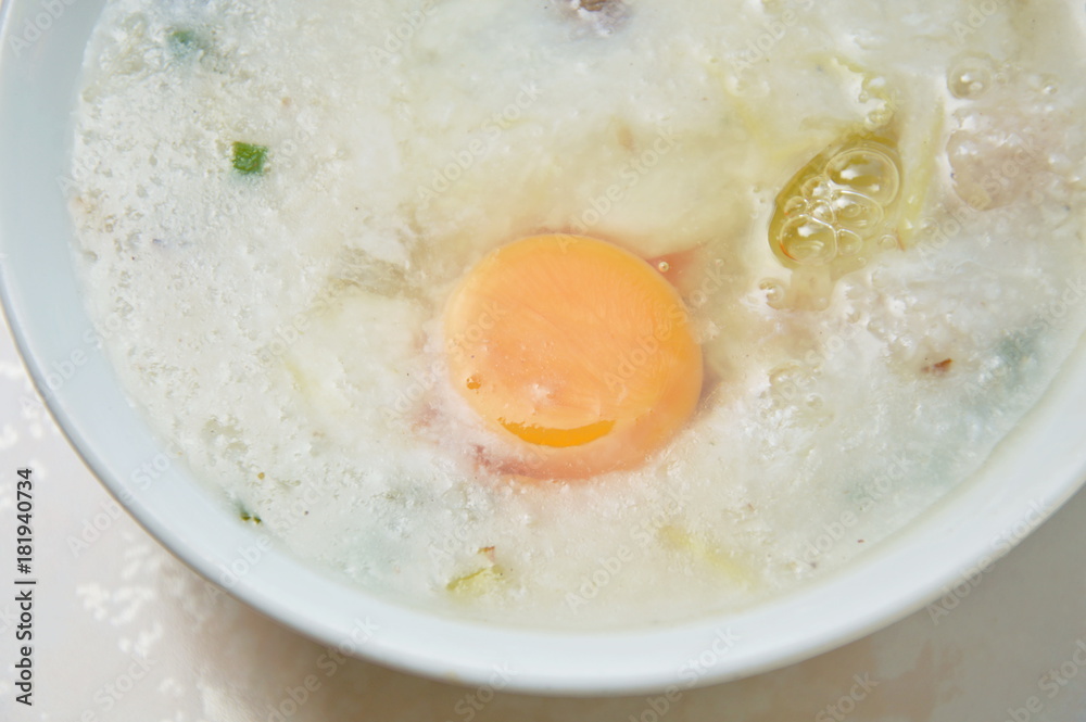 rice porridge with pork topping egg yolk on bowl rice porridge with pork topping egg yolk on bowl