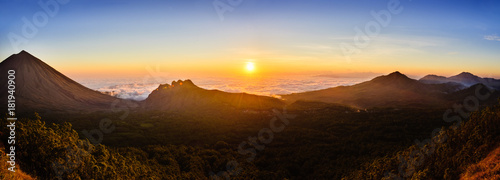 Indonesia's Ring of Fire - Panoramic view of Flores sunset over fog bank, showing Mount Inerie and eroded volcanoes photo