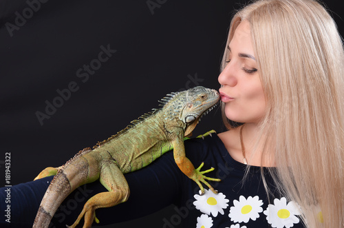 Beautiful girl portrait and green iguana