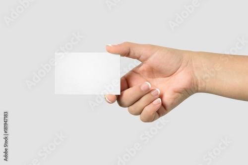 Mockup of female hand holding a Business Card isolated on light grey background. Size 85x 55 mm.