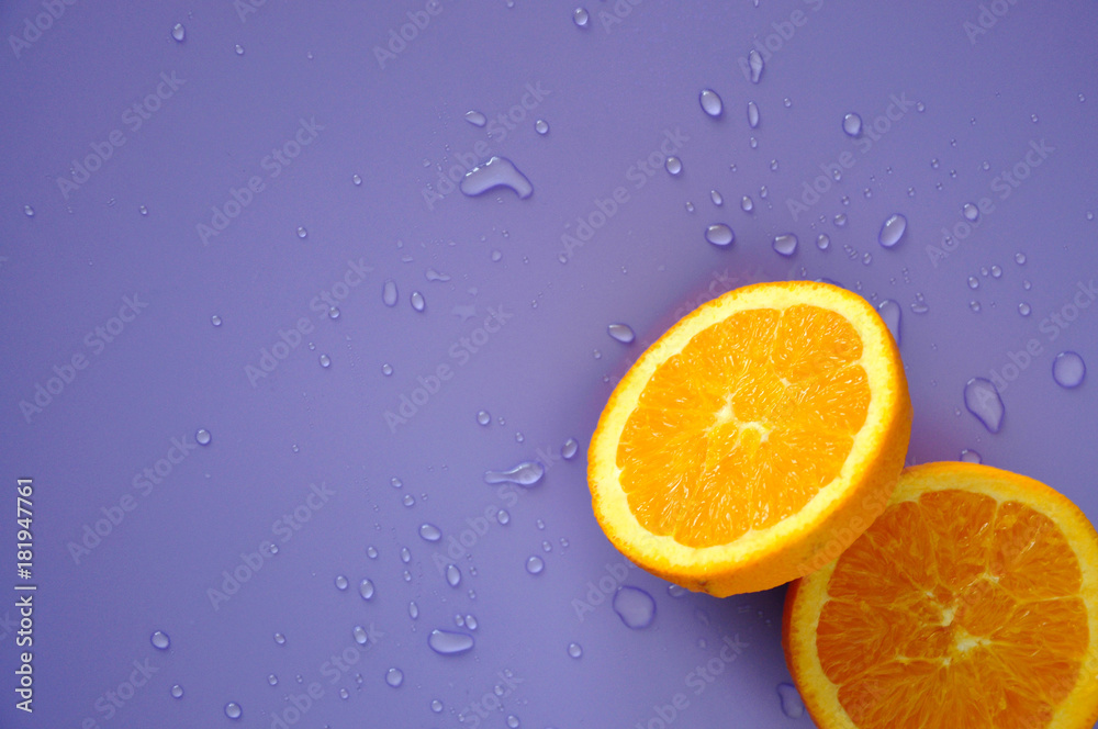 Cut Half of Navel Orange on Purple Background Cut Half of Navel Orange on Purple Background