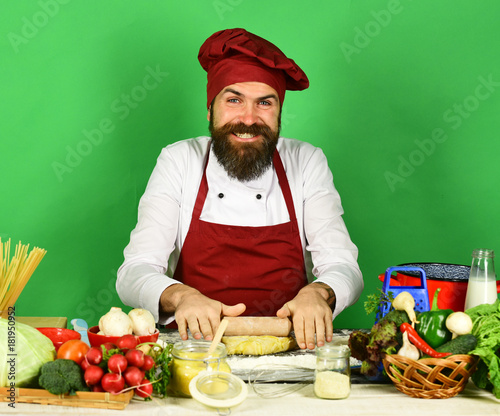 Homemade food concept. Chef with pasta, vegetables and dough photo