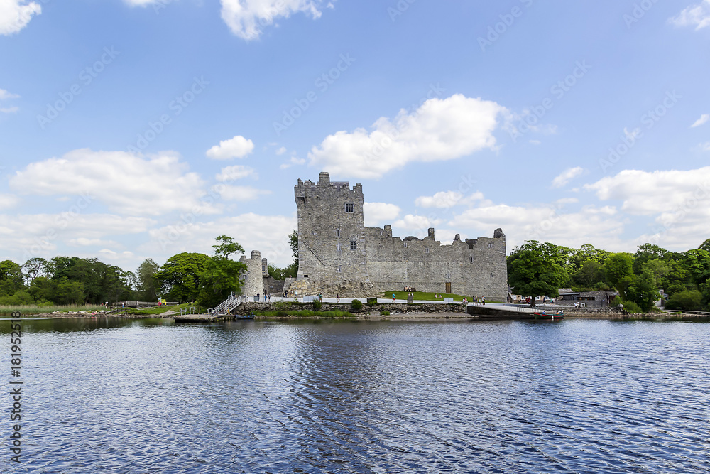 View of Ross Castle from lake with pier in Killarney national park