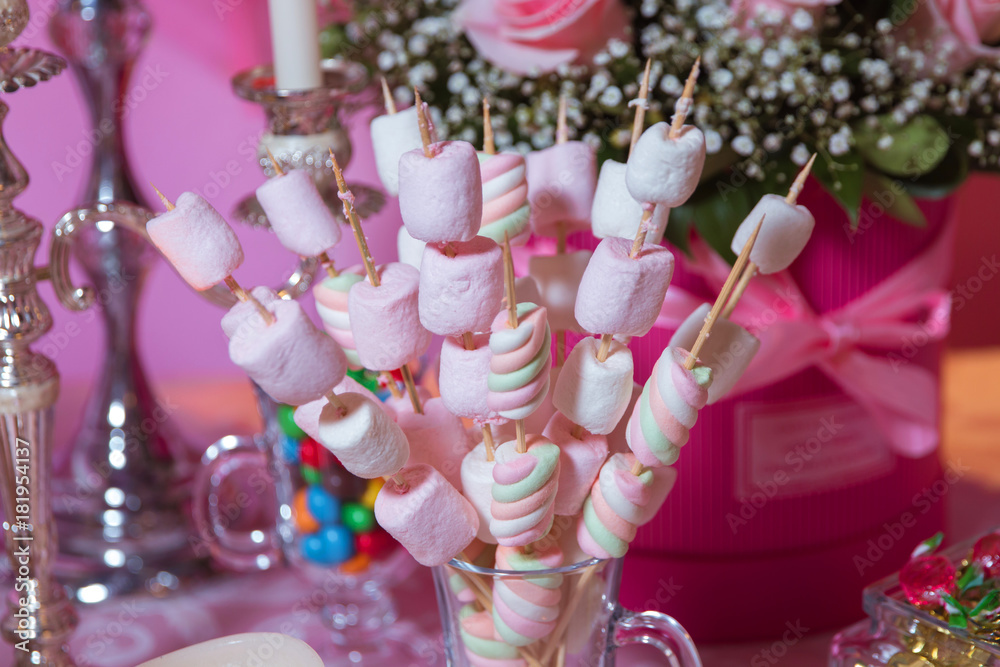 Candy Bar. Dessert table for a party. Marshmallow skewers