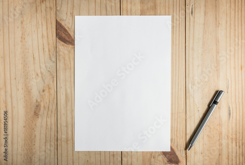 white paper and gray pencil on wooden background