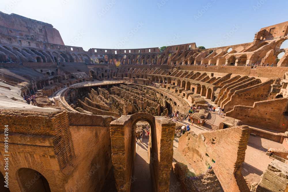 The central oval arena of the ancient roman coliseum, Rome, Italy, with tiered terraces, at sunrise.