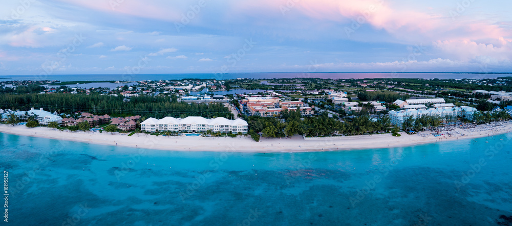 aerial panoramic view of seven mile beach in the tropical paradise of the cayman islands in the caribbean sea after sunset