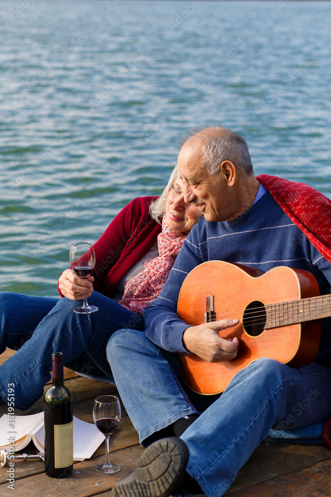 Happy senior couple enjoying time together by the lake.