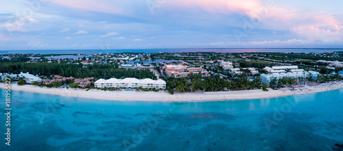 aerial panoramic view of seven mile beach in the tropical paradise of the cayman islands in the caribbean sea after sunset