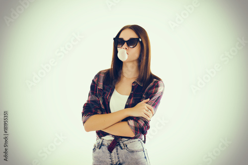 Young cute girl chews bubble gum 