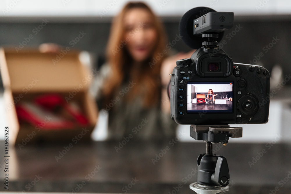 Smiling young girl recording her video blog episode