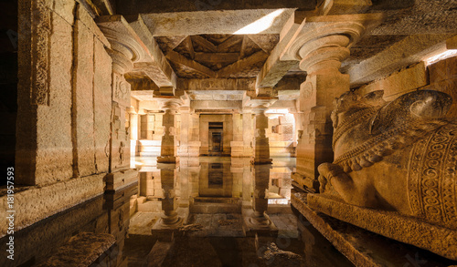 Flooded underground Shiva temple with water reflection in Hampi, Karnataka, India.