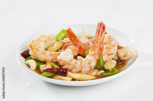 cajun Shrimps with cashew nuts stir fry vegetables on white plate with white background 