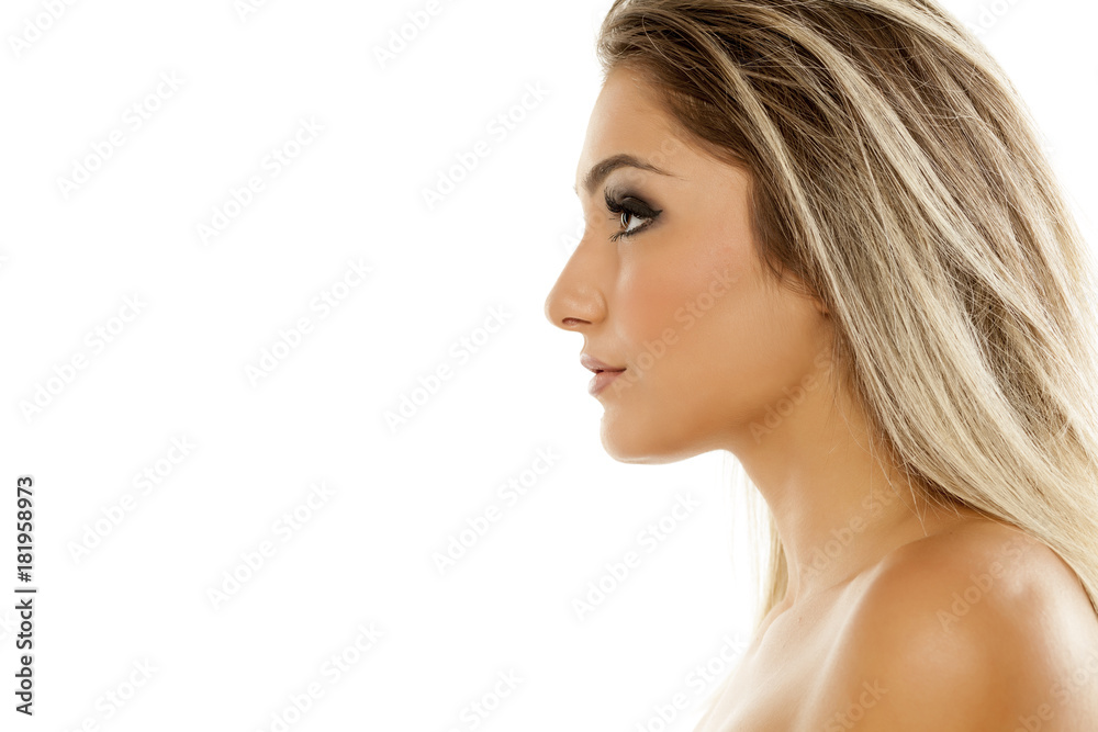Profile of serious beautiful young woman on white background Profile of serious beautiful young woman on white background