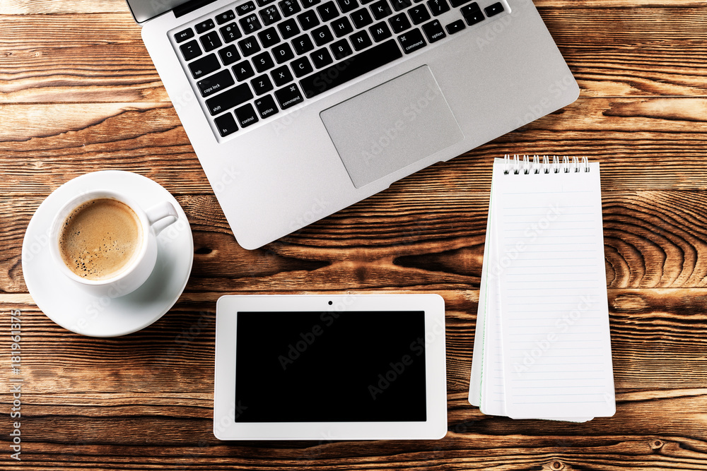 Top view of studying process with copybook, book and laptop. Cups of coffee on the table Top view of studying process with copybook, book and laptop. Cups of coffee on the table