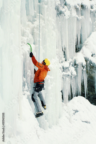 Ice climbing the North Caucasus, man climbing frozen waterfall.
